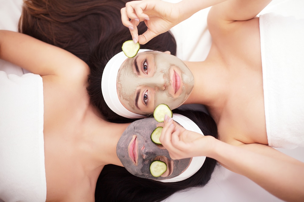 women getting cucumber facials