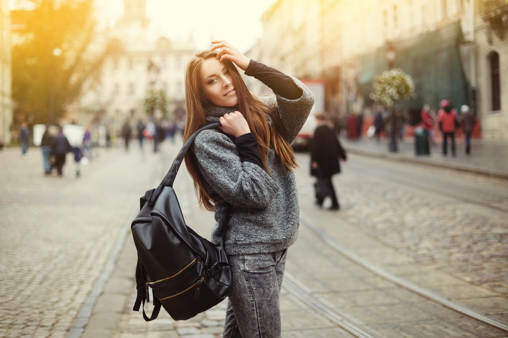 female student walking in a quad