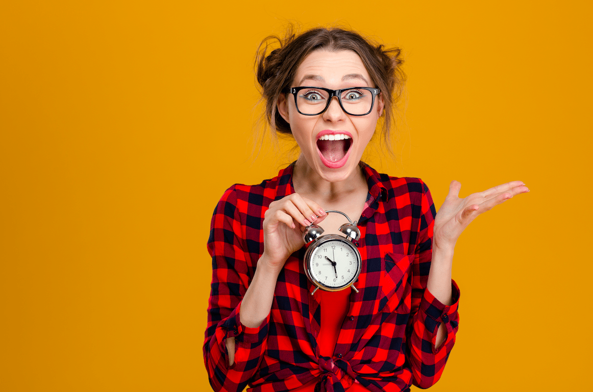 A confused woman holding a clock, because clocks have hours, and hours are cool- but also very confusing.