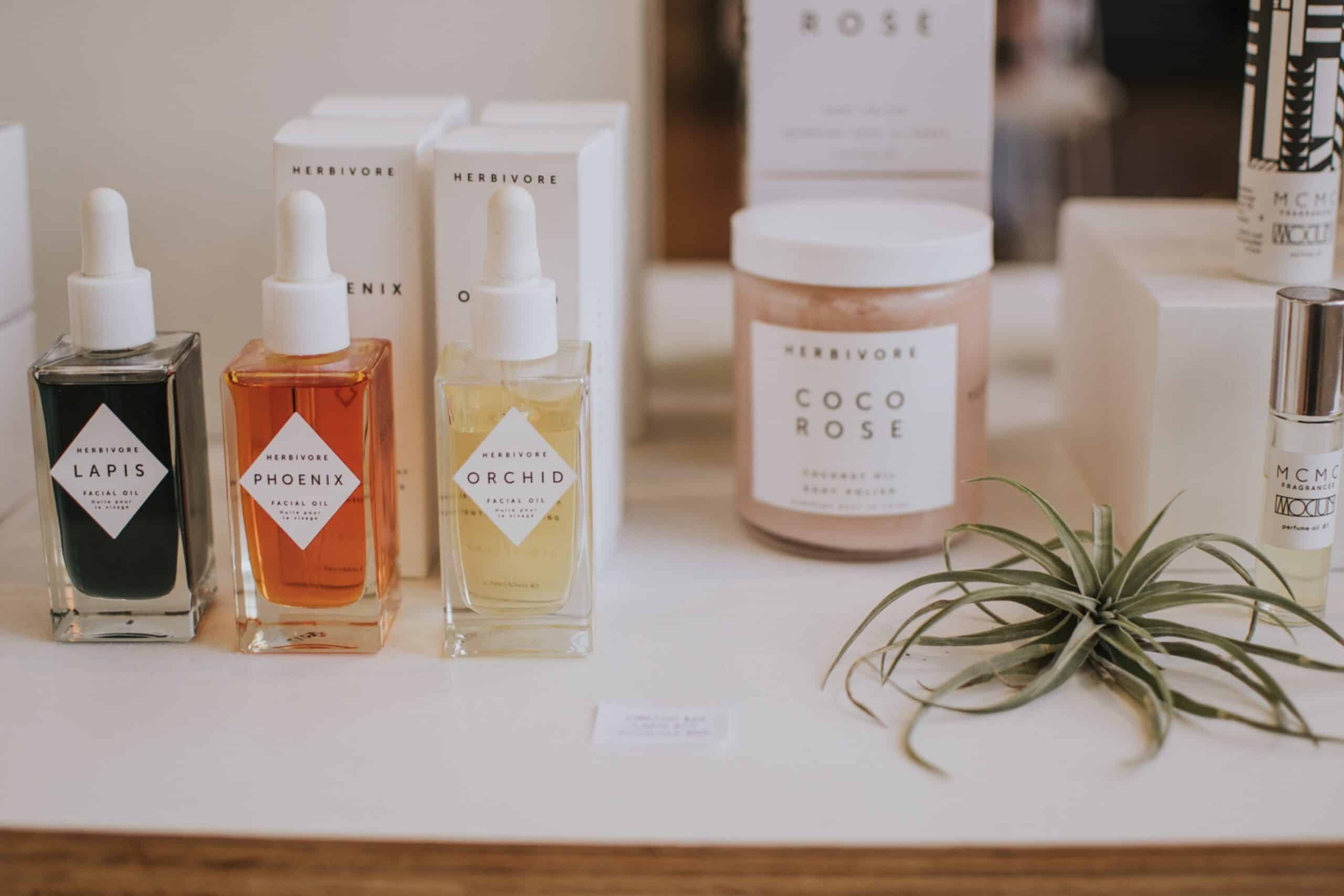 skin care products are on a counter with plants
