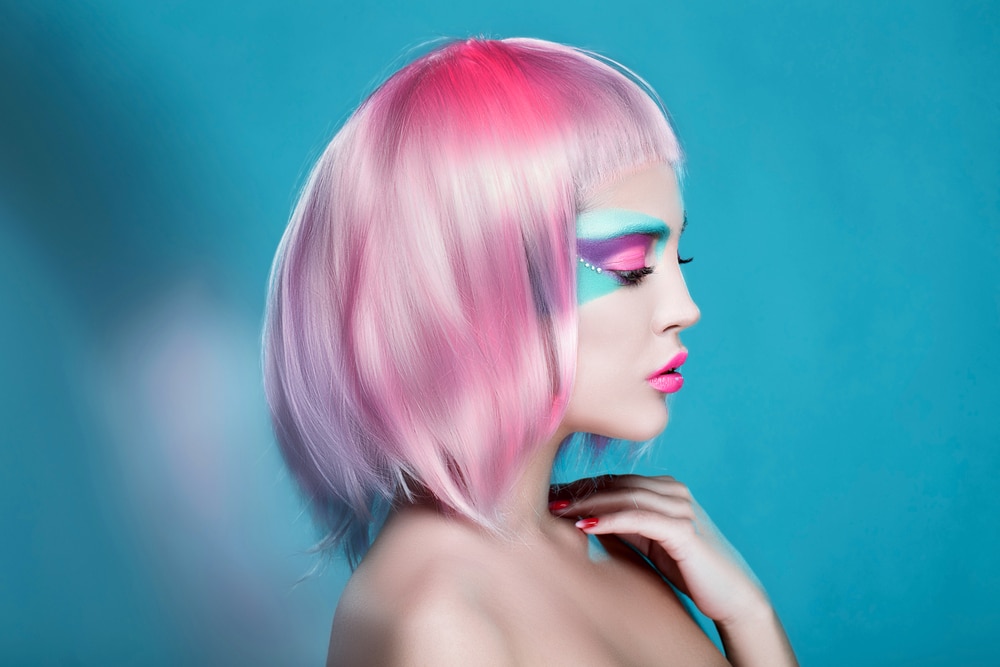 girl with turqoise and pink makeup and pink hair
