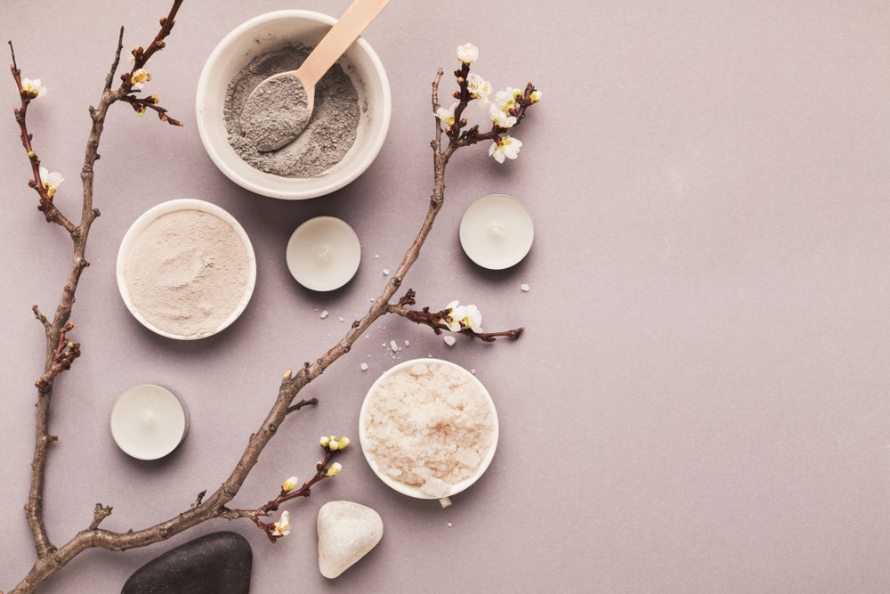 Filled apothecary bowls lined up with blooming tree branch