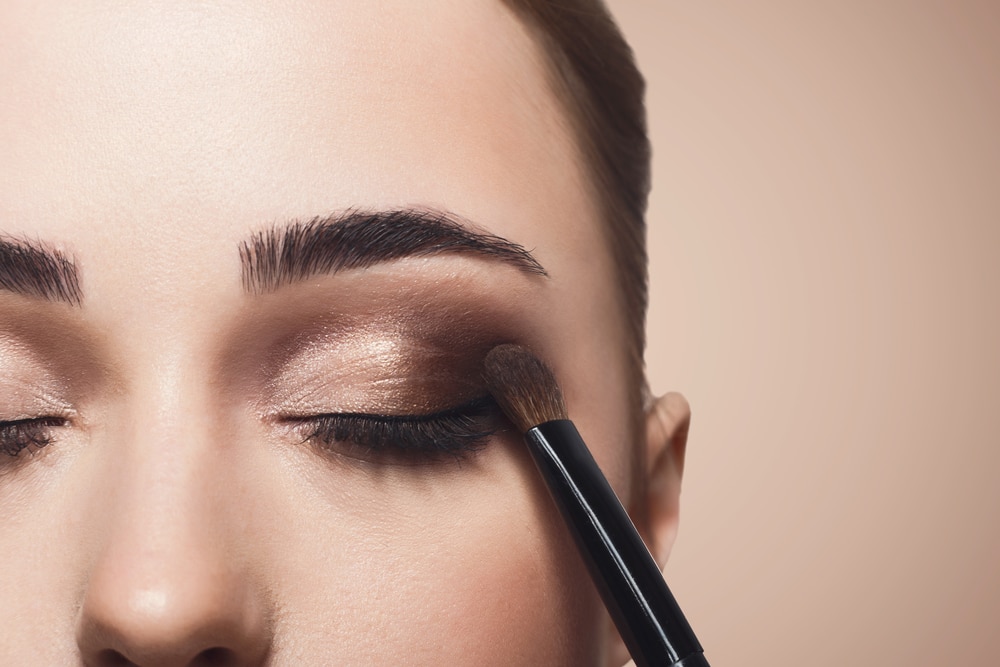 woman's face having dark eyeshadow applied