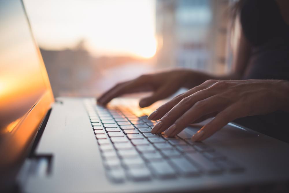 woman typing on keyboard