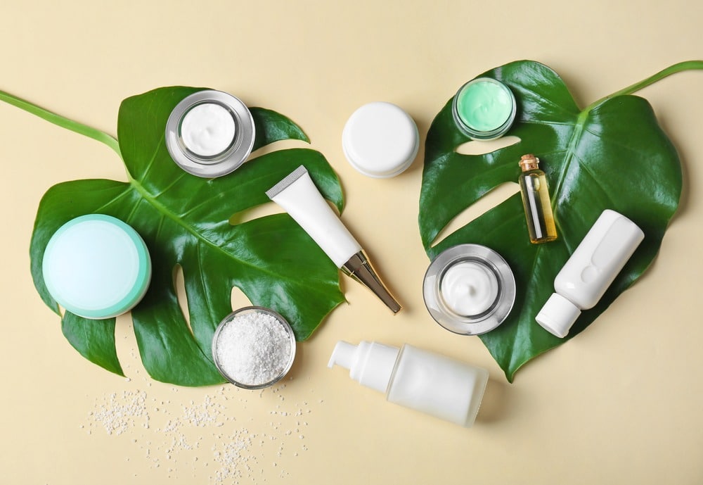 skin care products resting on leaf