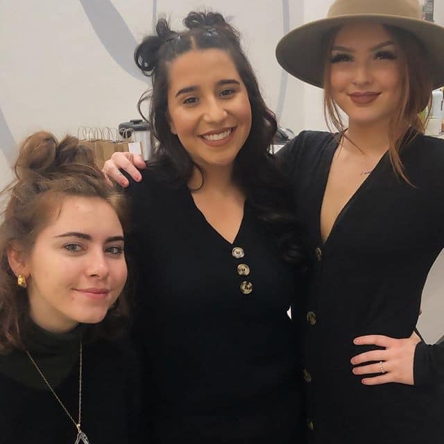 three students smiling at the camera